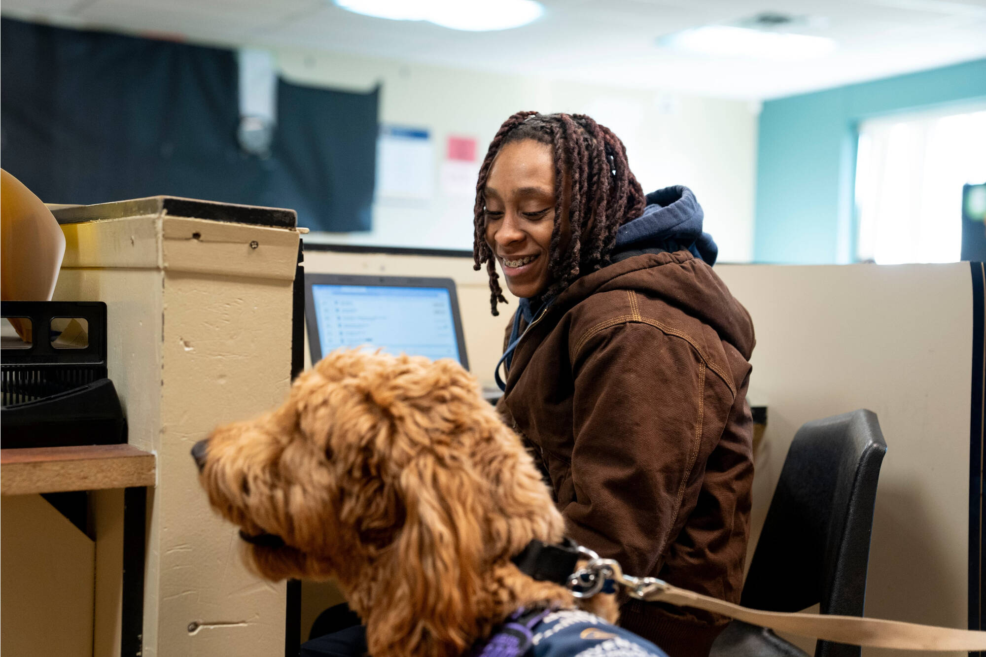 student interacting with Beau the dog